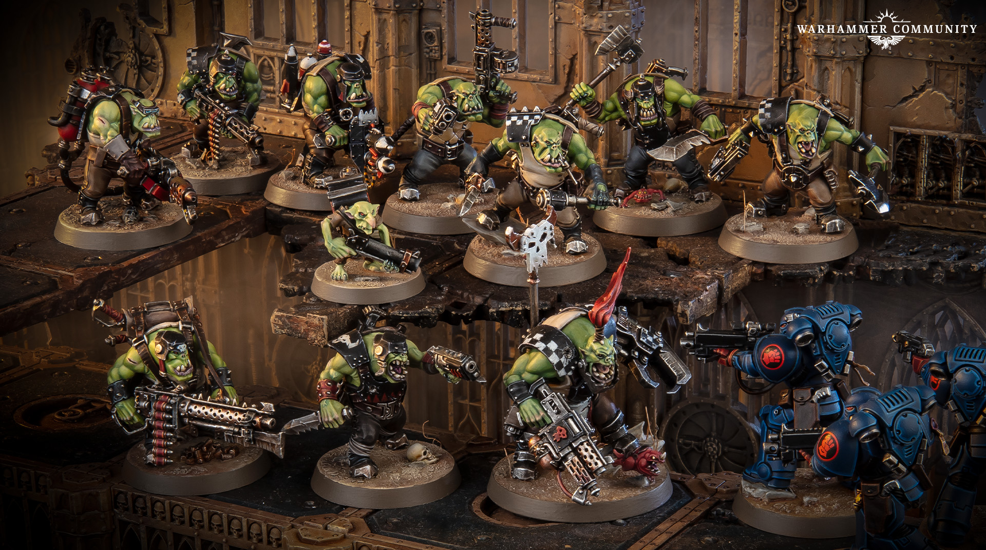 A mob of newly revealed Ork Boyz on ruined terrain, each model built with a different head, weapon and pose