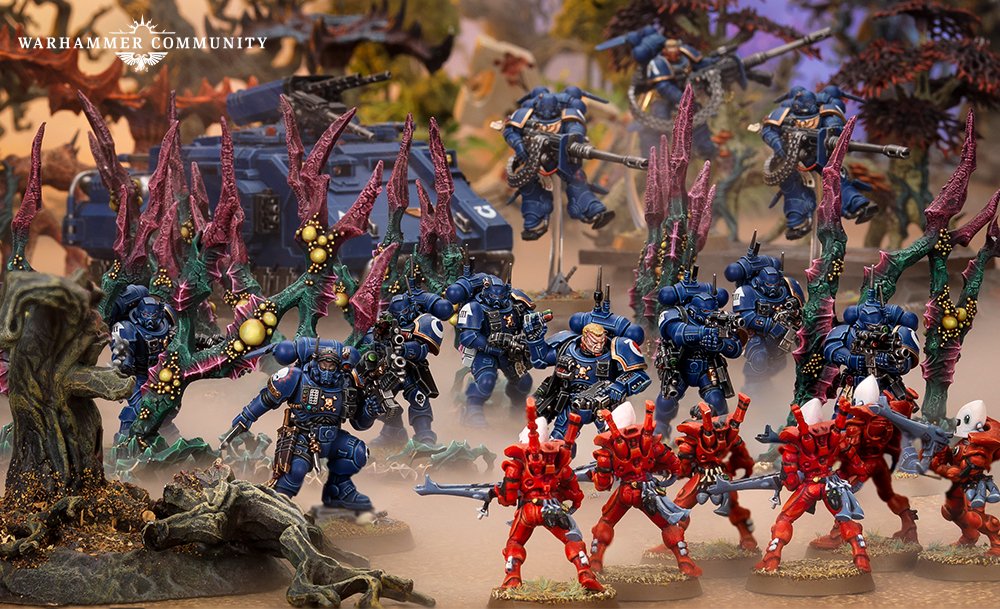 A Phobos Vanguard force advancing through alien terrain, snipers and jump-pack Suppressors in support
