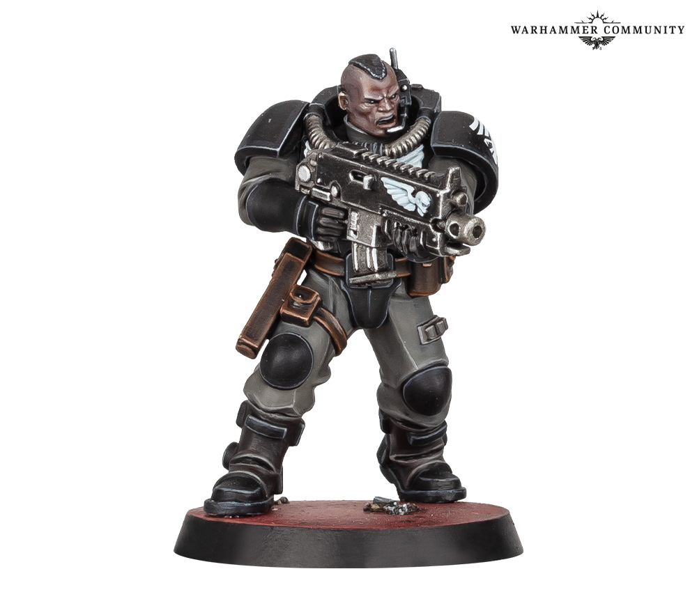 September's Miniature of the Month, a Space Marine Scout in black partial plate over grey fatigues, shouldering an astartes shotgun
