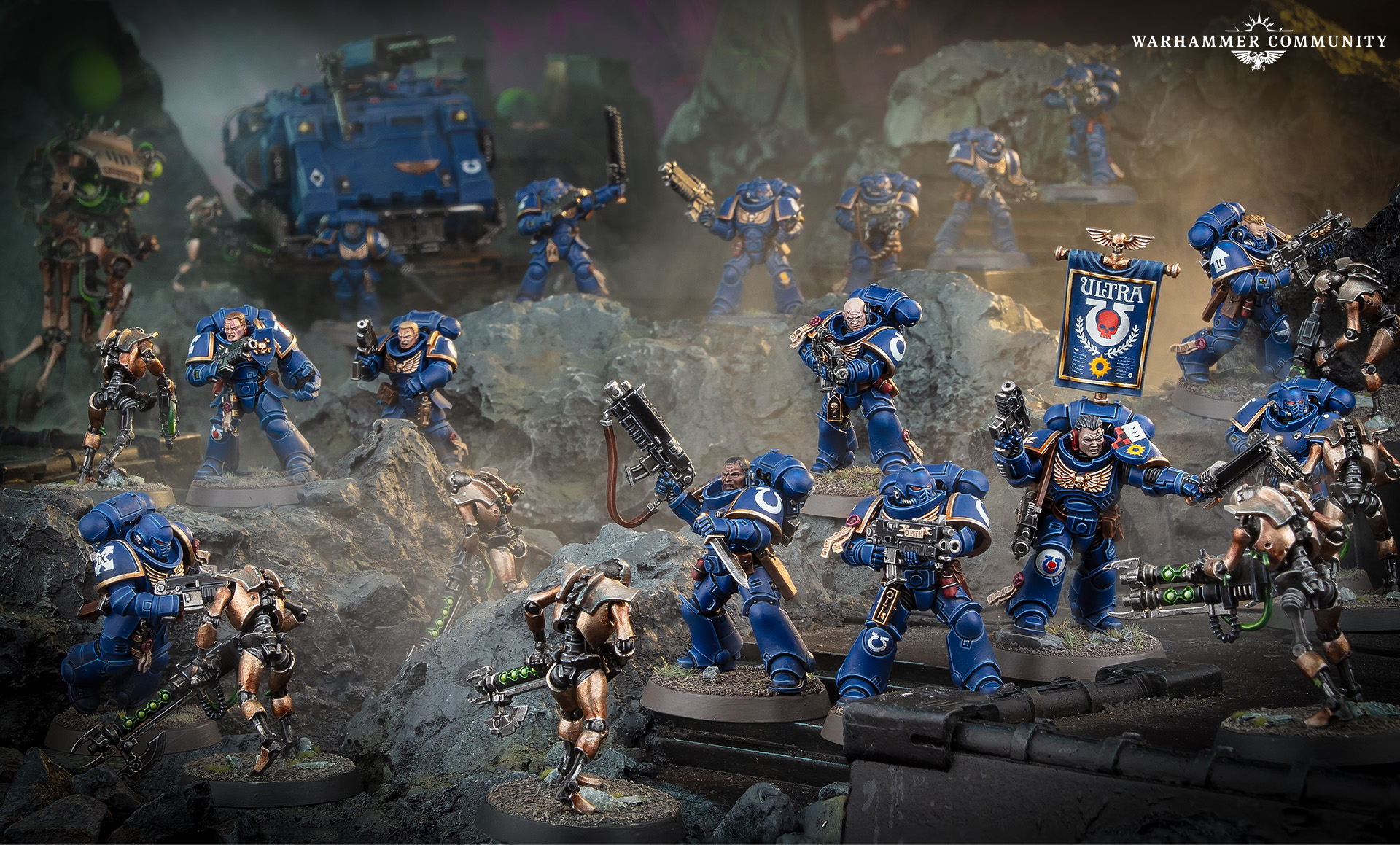 An Ultramarines force with a Rhino and company banner fighting Necrons among grey rocks